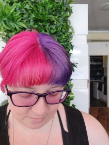 spilt dyed hair with pink on the left and purple on the right
